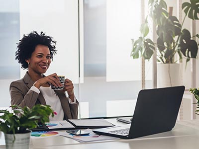 Businesswoman happy in office with coffee